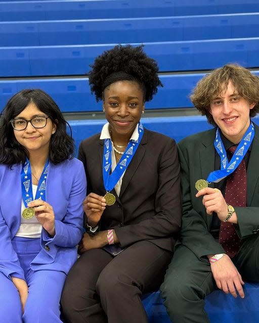 Riya Singh, Nkechi Onyejekwe and Philip Rasmussen of Pueblo West High School pose with their 4A CHSAA Speech and Debate Champion medals on Feb. 25.