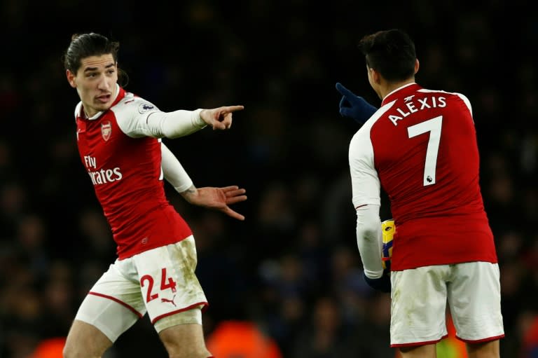 Arsenal's Hector Bellerin (L) celebrates after scoring a goal with teammate Alexis Sanchez during their English Premier League match against Chelsea, at the Emirates Stadium in London, on January 3, 2018