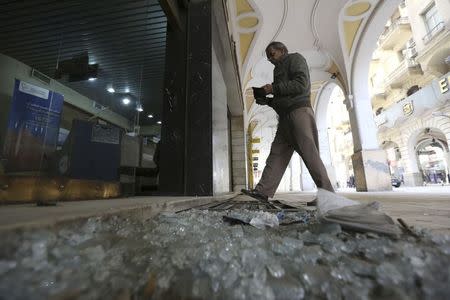 A man walks past debris from a damaged shop after a blast hit central Cairo February 3, 2015. REUTERS/Mohamed Abd El Ghany