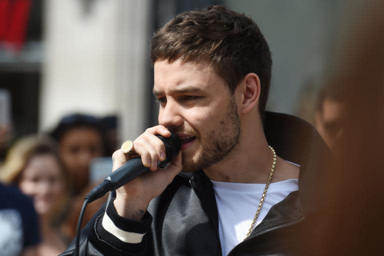 Liam Payne surprises shoppers by busking outside Oxford Street tube