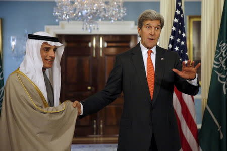 U.S. Secretary of State John Kerry (R) reacts to a question from a journalist as he shakes hands with Saudi Foreign Minister Adel al-Jubeir during a meeting at the State Department in Washington, February 8, 2016. REUTERS/Carlos Barria