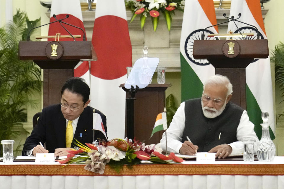 Indian Prime Minister Narendra Modi and his Japanese counterpart Fumio Kishida sign agreements in New Delhi, Saturday, March 19, 2022. Kishida Saturday said his country will invest $42 billion in India over the next five years in a deal that is expected to boost bilateral trade between New Delhi and Tokyo. (AP Photo/Manish Swarup)
