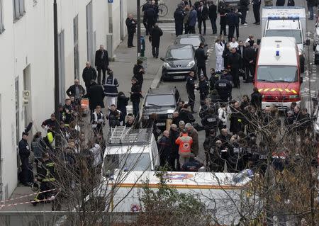 FILE PHOTO: General view of police and rescue vehicles at the scene after a shooting at the Paris offices of Charlie Hebdo, a satirical newspaper, January 7, 2015. REUTERS/Philippe Wojazer