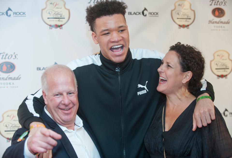 Mike Vine, owner of several car dealerships in Louisville including Blue Grass Automotive, left, and Sheri Cohen, right, pose with former University of Kentucky basketball star and current player for the NY Knicks, Kevin Knox.03 May 2019