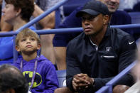 Tennis - US Open - Semifinals - New York, U.S. - September 8, 2017 - Golfer Tiger Woods sits with his son Charlie as they watch Rafael Nadal of Spain in action against Juan Martin del Potro of Argentina. REUTERS/Mike Segar