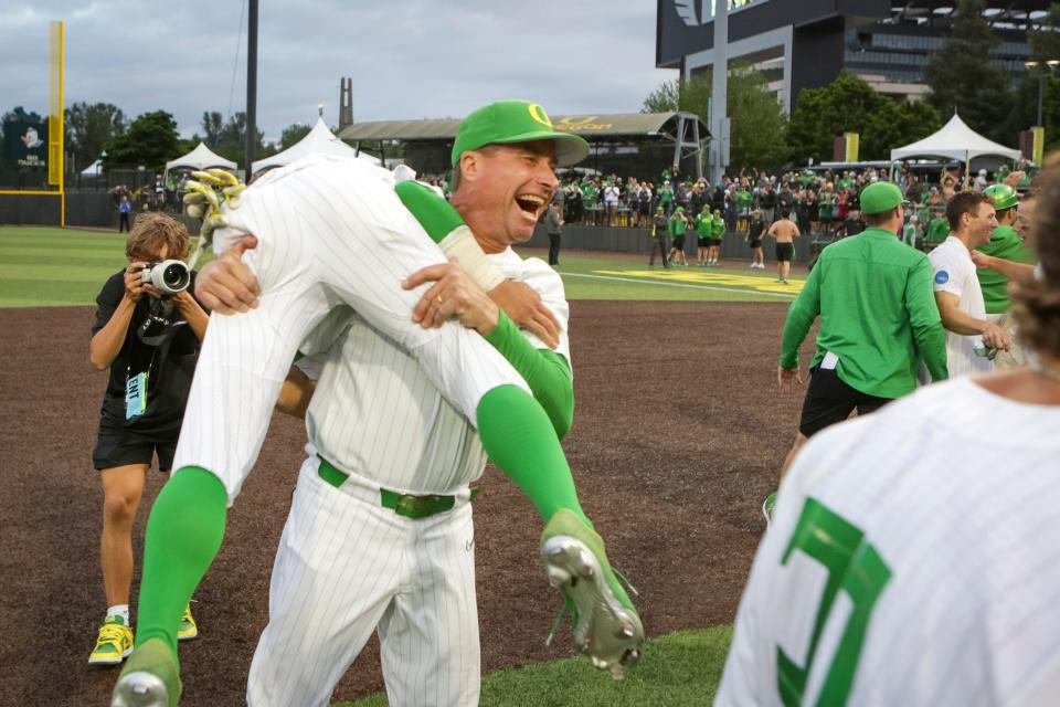 Oregon head coach Mark Wasikowski carries infielder Rikuu Nishida as the Oregon Ducks defeated Oral Roberts University 9-8 in the first game of a best of three NCAA Super Regional series at PK Park in Eugene, Ore. Friday, June 9, 2023. 