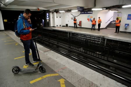 A passenger waits on a platform at the Gare du Nord metro station during a strike by all unions of the Paris transport network (RATP) against pension reform plans in Paris