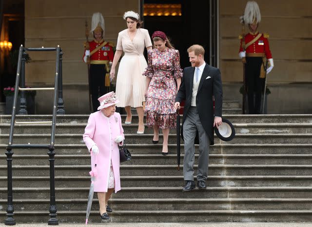 <p>YUI MOK/POOL/AFP via Getty</p> Queen Elizabeth, Princess Eugenie, Princess Beatrice and Prince Harry at a Buckingham Palace garden party on May 29, 2019.