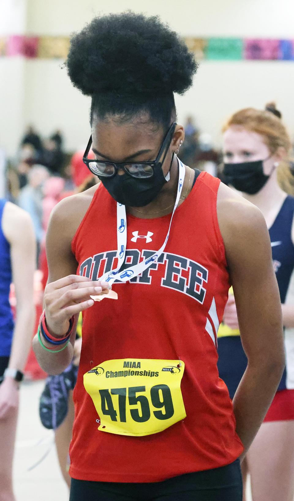 Durfee's Shakira Cadet, looks at her medal  from the 55M  dash during the Division 1 Indoor Track Tournament at the Reggie Lewis Track and Athletic Center in Boston on Saturday, Feb. 19, 2022.