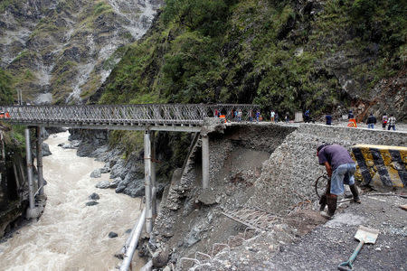 A partially damaged bridge at the height of Typhoon Haima is pictured in Benguet province, Philippines October 21, 2016. REUTERS/Erik De Castro