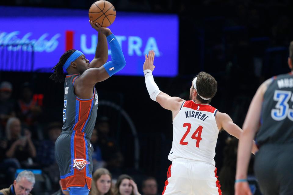 Oklahoma City Thunder guard Luguentz Dort (5) shoots a 3-pointer over Washington Wizards forward Corey Kispert (24) during an NBA basketball game between the Oklahoma City Thunder and the Washington Wizards at Paycom Center, Friday, Jan. 6, 2023. 