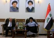 Iraqi Prime Minister Haider al-Abadi, who's political bloc came third in a May parliamentary election, (L) meets with cleric Moqtada al-Sadr, who's bloc came first, in Najaf, Iraq June 23, 2018. REUTERS/Alaa al-Marjani