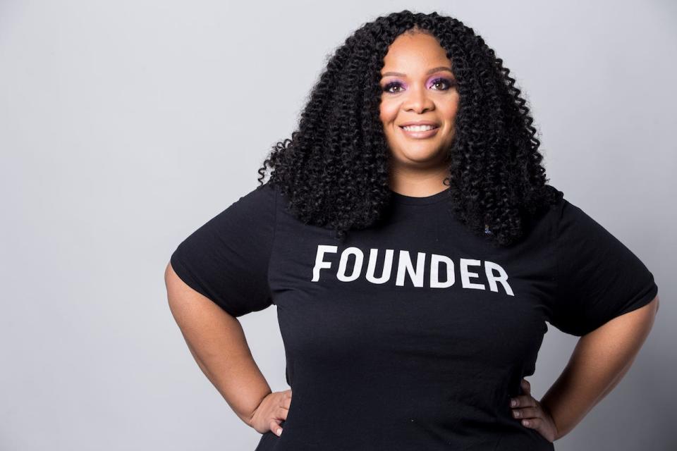 Kimberly Wilson stands wearing a black shirt with the word Founder written on it