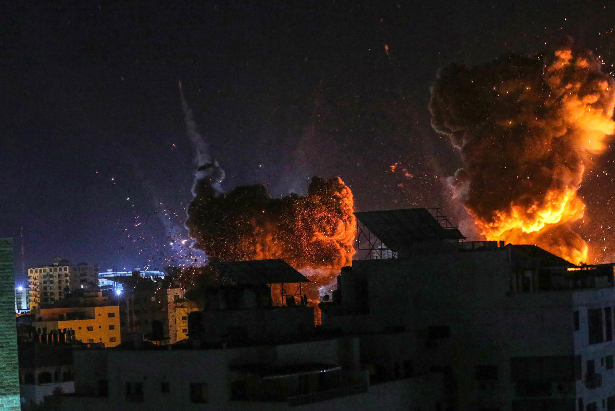 Fire and smoke rise above buildings in Gaza City as Israeli warplanes target a governmental building, early on May 18, 2021 in Gaza City, Gaza. (Fatima Shbair/Getty Images)
