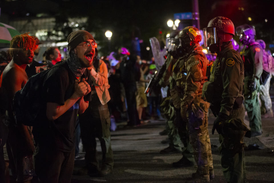 A protester screams at federal officers after they used tear gas and less-lethal weapons to disperse a protest against racial injustice and police brutality in front of the Mark O. Hatfield U.S. Courthouse in the early hours of July 30, 2020 in Portland, Oregon. (Nathan Howard/Getty Images)