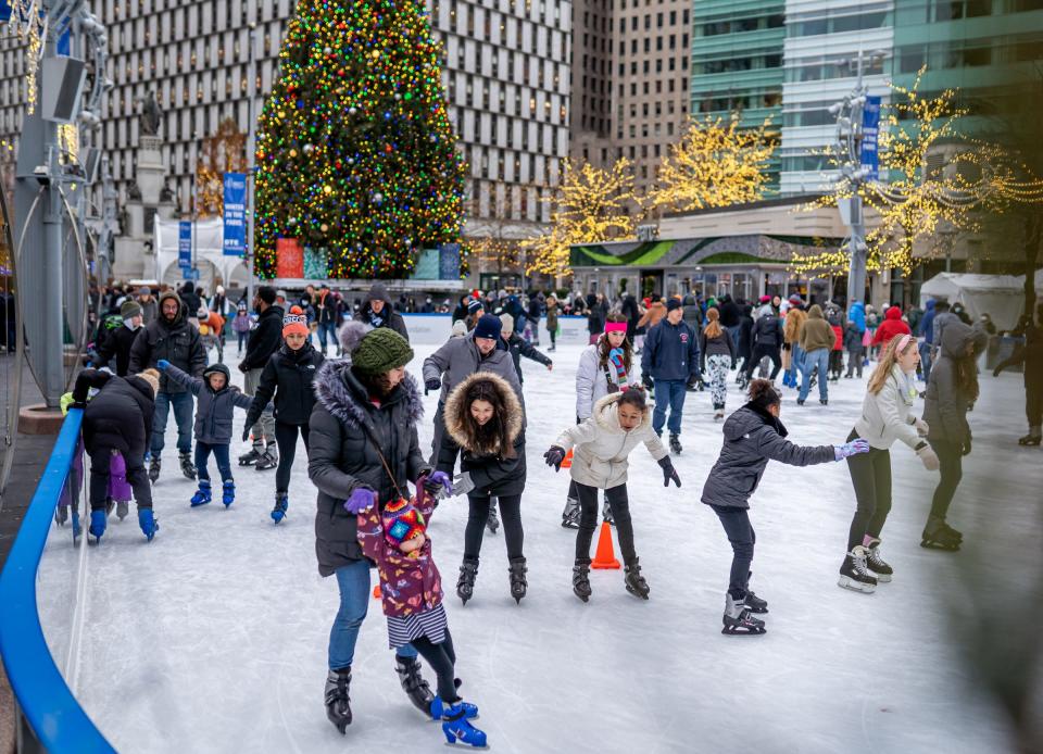 People make their way around while Ice skating at The Rink at Campus Martius Park in downtown Detroit on November 26, 2021.