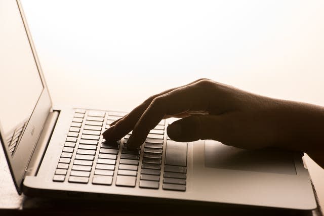  A woman’s hands on a laptop keyboard