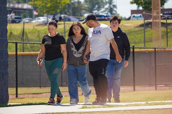 WINDER, GEORGIA - SEPTEMBER 4: Students walk off campus with their families after a shooting at Apalachee High School on September 4, 2024 in Winder, Georgia. Four fatalities and multiple injuries have been reported, and a 14-year-old suspect is in custody according to authorities. (Photo by Megan Varner/Getty Images)