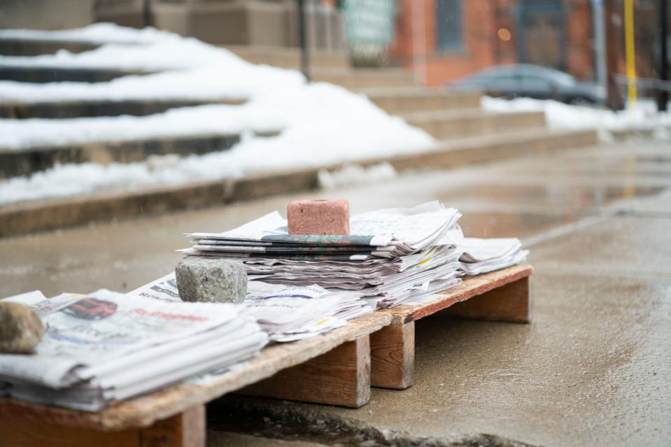 Battle Creek resident Bob Reichel with newspapers for sale on the corner of Capital Avenue and Van Buren Street on Wednesday, Jan. 24, 2024.