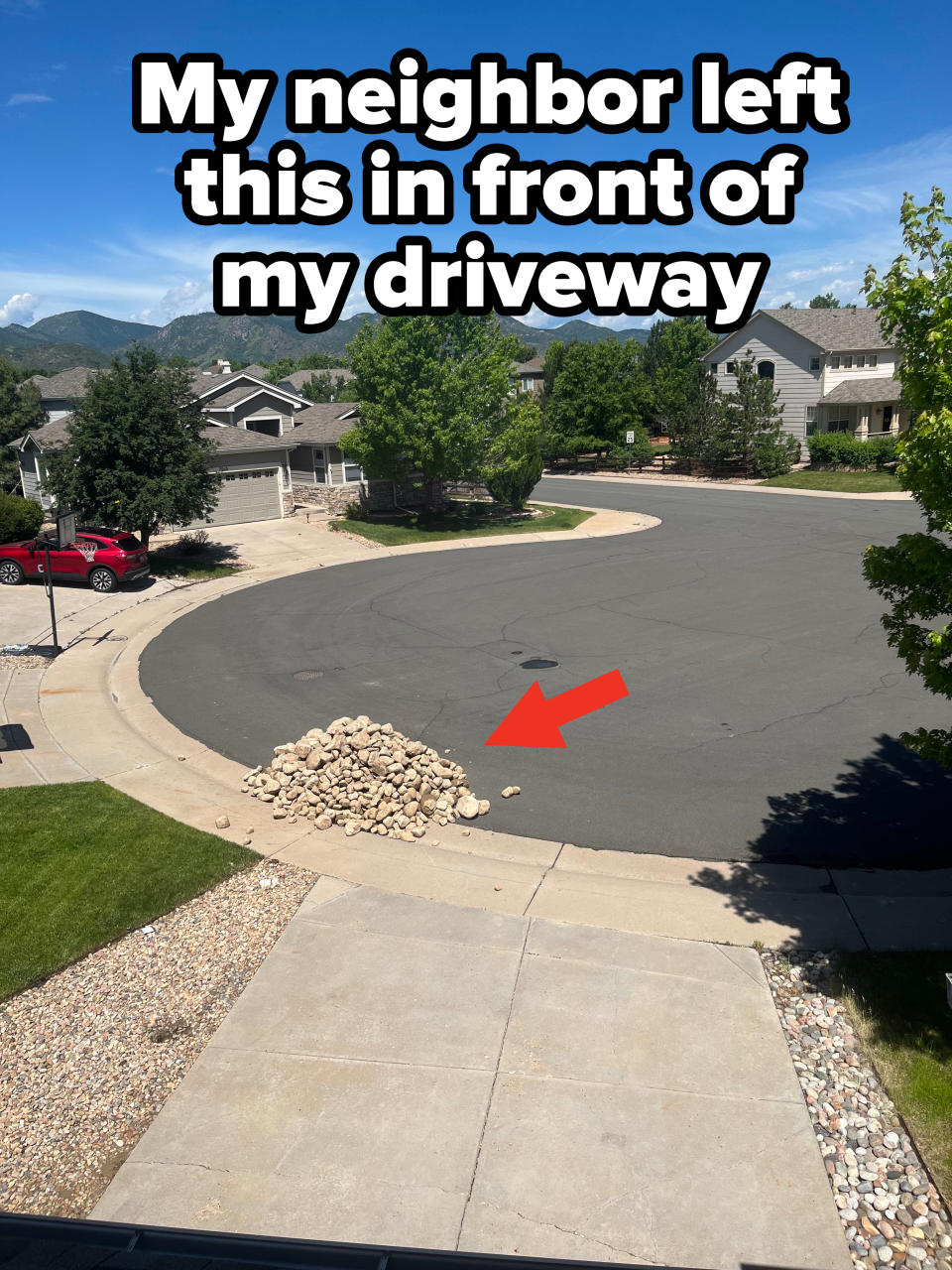 A pile of rocks at the end of a driveway