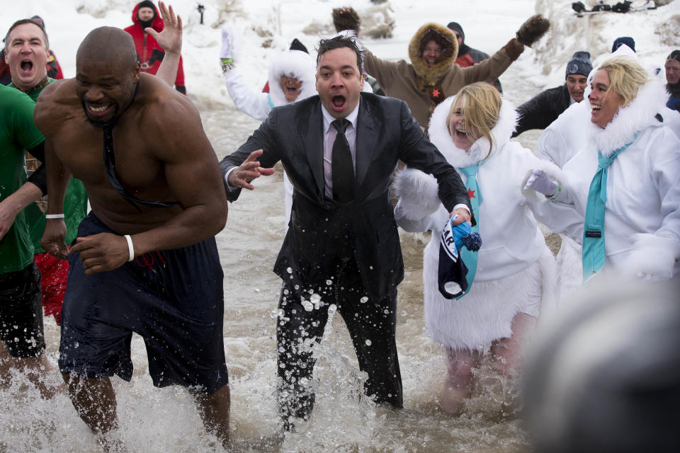 "The Tonight Show" host Jimmy Fallon, center, exits the water during the Chicago Polar Plunge, Sunday, March 2, 2014, in Chicago. Fallon joined Chicago Mayor Rahm Emanuel in the event. (AP Photo/Andrew A. Nelles)