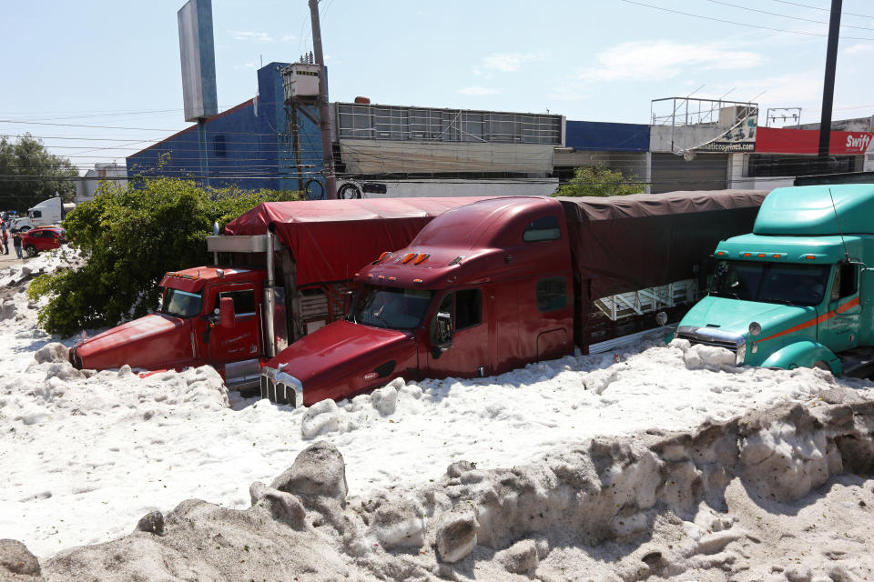 Trucks are buried in ice after a heavy storm of rain and hail which affected some areas of the city in ??Guadalajara, Mexico June 30, 2019. REUTERS/Fernando Carranza