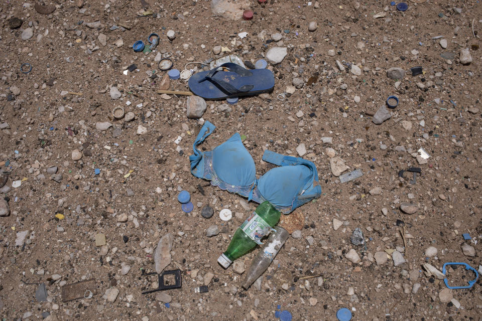 This July 28, 2019 photo shows a bra on the ground where African migrants are held in desert compounds, known in Arabic as "hosh" in Shabwa, Yemen. Many migrants are subjected to daily torments ranging from beatings and rapes to starvation. (AP Photo/Nariman El-Mofty)