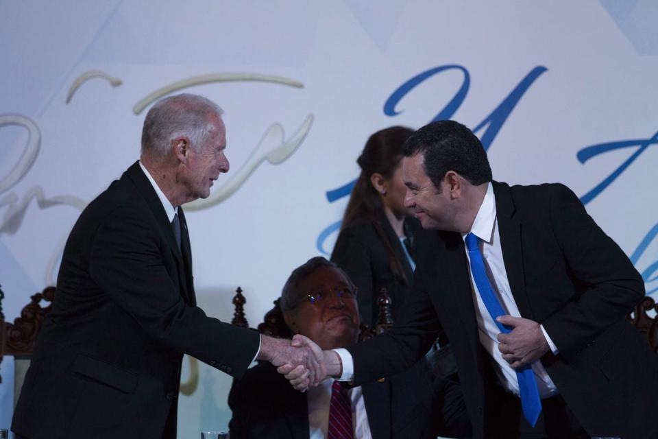 Two men in suits shaking hands