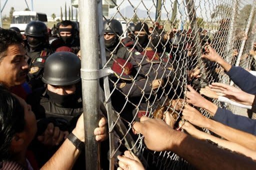 Relatives of inmates at Apodaca prison pull the security fence following a riot inside the prison near Monterrey, state of Nuevo Leon, Mexico. At least 44 inmates were killed in a Mexican prison riot on Sunday, just days after a deadly inferno in a jail in Honduras, again highlighting terrible overcrowding in Latin American prisons