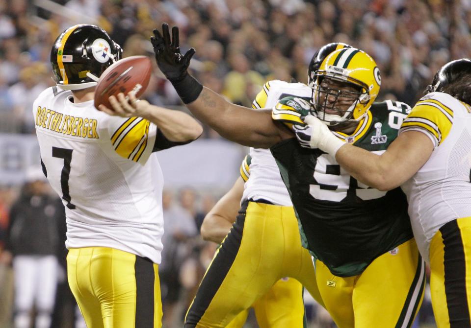 2011: The Green Bay Packers' Howard Green (95) applies pressure to Pittsburgh Steelers quarterback Ben Roethlisberger (7), causing him to throw an interception which resulted in a Green Bay touchdown during Super Bowl XLV in Arlington, Texas.