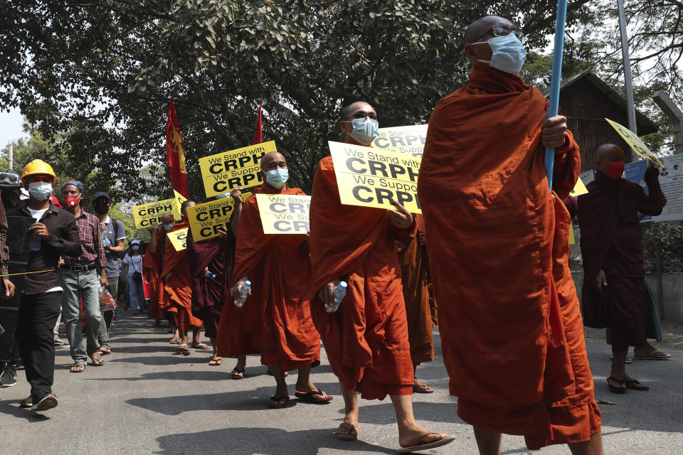 Monks hold signs as they march during an anti-coup protest in Mandalay, Myanmar, Saturday, March 6, 2021. The U.N. special envoy for Myanmar on Friday called for urgent Security Council action, saying about 50 peaceful protesters were killed and scores were injured in the military's worst crackdowns this week. (AP Photo)