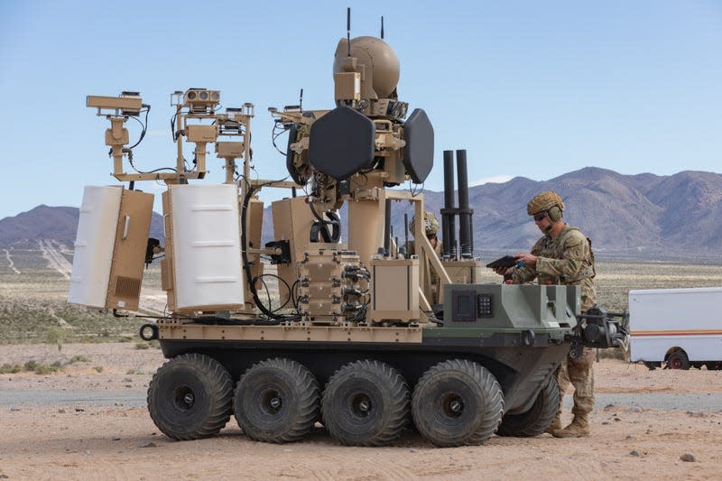 A U.S. Army unmanned, eight-wheeled, all-electric, all-terrain platform with a modular counter-small UAS system with a human-in-the-loop operational system under the Family of Counter Unmanned System or FoCUS provides support to dismounted Soldiers in an urban training environment as part of a human integration experiment at Fort Irwin, Calif., March 18, 2024. - Photo: U.S. Army photo by Sgt. Brahim Douglas