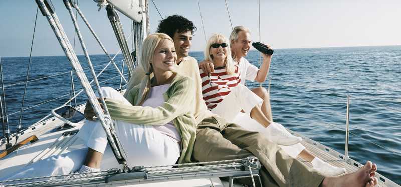 Two couples lounge on a yacht.