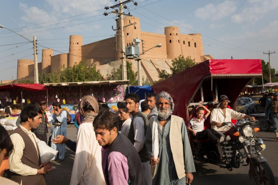 Street life in front of the Herat's ancient citadel, which was restored by the Aga Khan Trust for Culture.