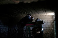 <p>An Iraqi police officer looks out from a basement that was previously used as a sniper position by the Islamic State group, in the town of Abu Saif, south of Mosul, Tuesday, Feb. 21, 2017. A military spokesman says Iraqi forces are consolidating their gains south of Mosul ahead of moving deeper into the city’s Islamic State-held western half. The spokesman of the Joint Military Operation Command, Brig. Gen. Yahya Rasool, told The Associated Press that nearly 123 square kilometers — about 47 square miles — have been taken south of Mosul since the new push started on Sunday. (AP Photo/Bram Janssen) </p>