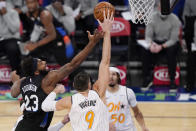 Orlando Magic center Nikola Vucevic (9) tips the ball away from New York Knicks center Mitchell Robinson (23) as Magic guard Cole Anthony (50) looks on during the first half of an NBA basketball game, Monday, Jan. 18, 2021, in New York. (AP Photo/Kathy Willens, Pool)