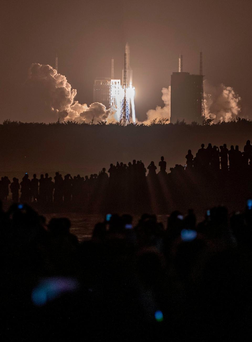 <p>A Long March 5 rocket carrying China's Chang'e-5 lunar probe launches from the Wenchang Space Center on China's southern Hainan Island on November 24,</p>AFP via Getty Images