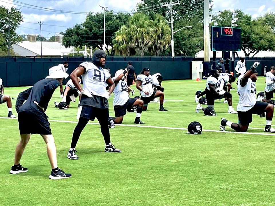 Jaguars defensive end Dawuane Smoot (91) works with a trainer during the team's stretching routine prior to Tuesday's practice at the Miller Electric Center.