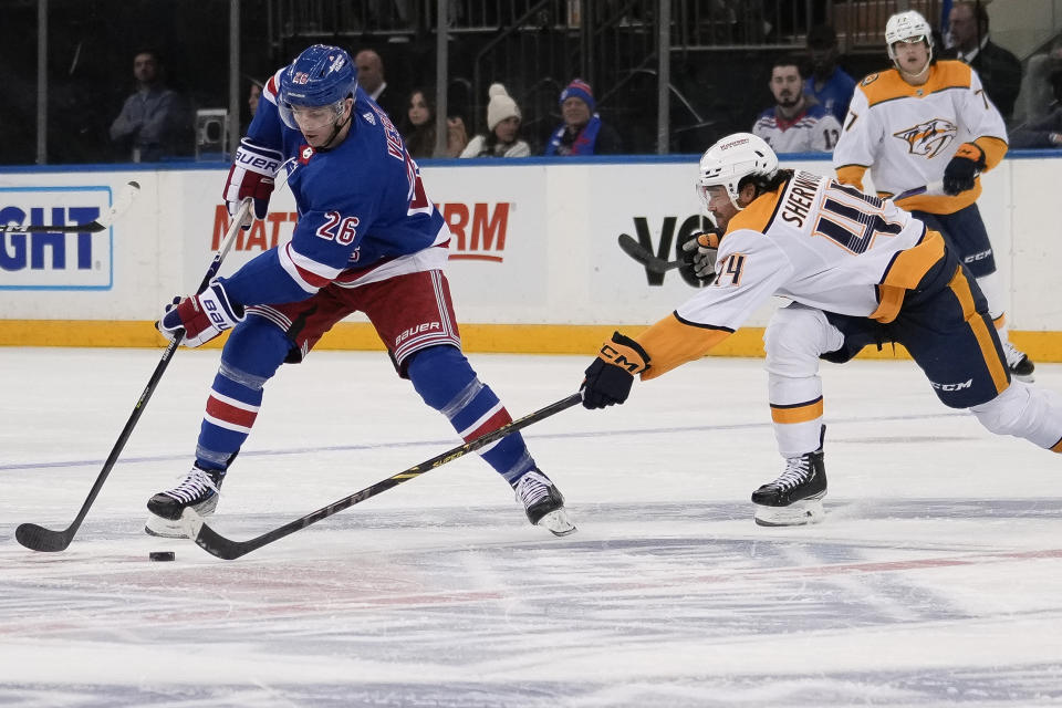 Nashville Predators left wing Kiefer Sherwood (44) defends against Nashville Predators New York Rangers left wing Jimmy Vesey (26) during the third period of an NHL hockey game Sunday, March 19, 2023, in New York. (AP Photo/Bryan Woolston)