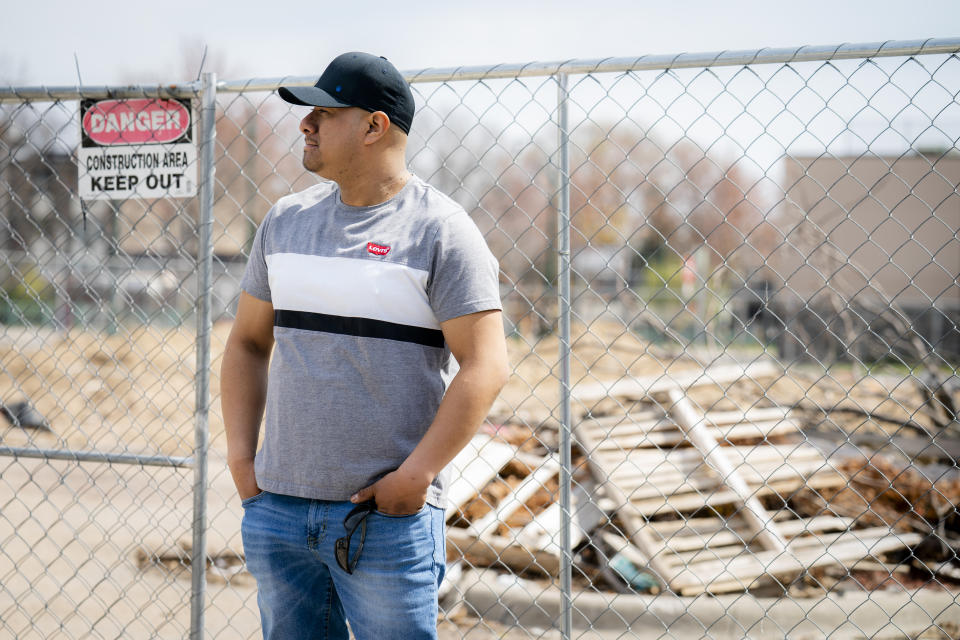 Fidel Martinez stands for a portrait at one of his former worksites in Minneapolis on Sunday, April 18, 2021. Martinez worked for a demolition contractor in the fall of 2020, demolishing several Walgreens stores and other structures. Martinez said the contractor owed him and his co-workers more than $20,000. His boss kept telling him the money was coming, but he would get his paychecks weeks late, and many of them he didn't get at all. (AP Photo/John Minchillo)