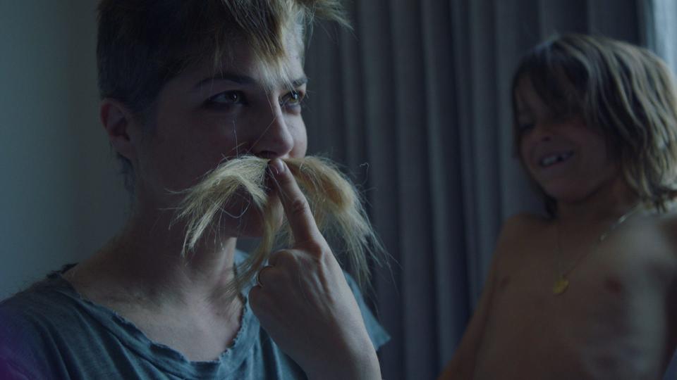 Selma Blair amuses her son, Arthur Saint Bleick, by making a mustache out of her shaved golden locks.