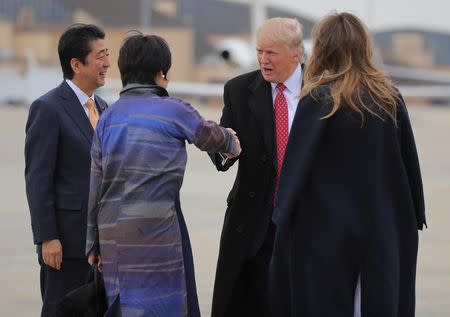 U.S. President Donald Trump (2ndR) greets Japanese Prime Minister Shinzo Abe (L) and his wife Akie Abe (2ndL) with Melania Trump, before boarding Air Force One at Joint Base Andrews, Maryland, U.S., February 10, 2017. REUTERS/Carlos Barria