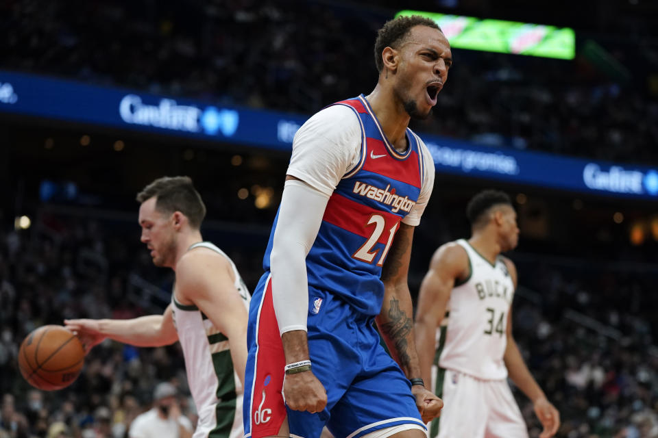 Washington Wizards center Daniel Gafford reacts after dunking on the Milwaukee Bucks in the second half of an NBA basketball game, Sunday, Nov. 7, 2021, in Washington. Washington won 101-94. (AP Photo/Patrick Semansky)