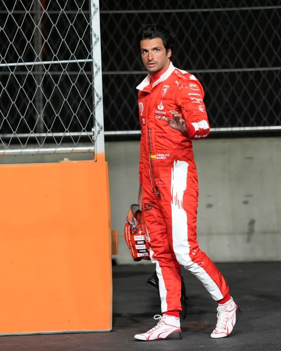 Ferrari driver Carlos Sainz, of Spain, waves to the fans after his car stopped on the track during the first practice session for the Formula One Las Vegas Grand Prix auto race, Thursday, Nov. 16, 2023, in Las Vegas. (AP Photo/Nick Didlick)