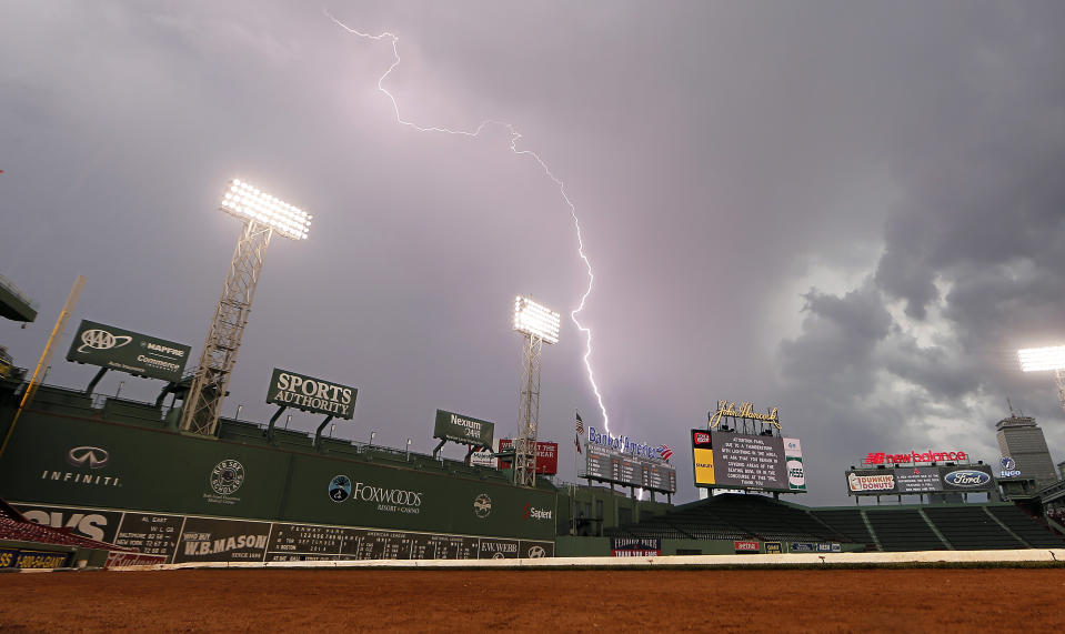 Lightning strikes over Fenway Park in Boston Saturday, Sept. 6, 2014 delaying the baseball game between the <a class="link " href="https://sports.yahoo.com/mlb/teams/boston/" data-i13n="sec:content-canvas;subsec:anchor_text;elm:context_link" data-ylk="slk:Boston Red Sox;sec:content-canvas;subsec:anchor_text;elm:context_link;itc:0">Boston Red Sox</a> and the <a class="link " href="https://sports.yahoo.com/mlb/teams/toronto/" data-i13n="sec:content-canvas;subsec:anchor_text;elm:context_link" data-ylk="slk:Toronto Blue Jays;sec:content-canvas;subsec:anchor_text;elm:context_link;itc:0">Toronto Blue Jays</a>. (AP Photo/Winslow Townson)