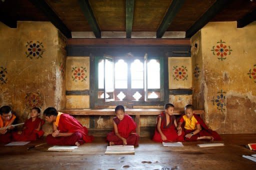 Young monks reciting religious texts in the Temple of the Divine Madman in the Bhutanese town of Punakha last October. The 31-year-old king of Bhutan, an Oxford-educated bachelor crowned in the remote Himalayan country in 2008, set up another royal wedding on Friday by announcing his engagement