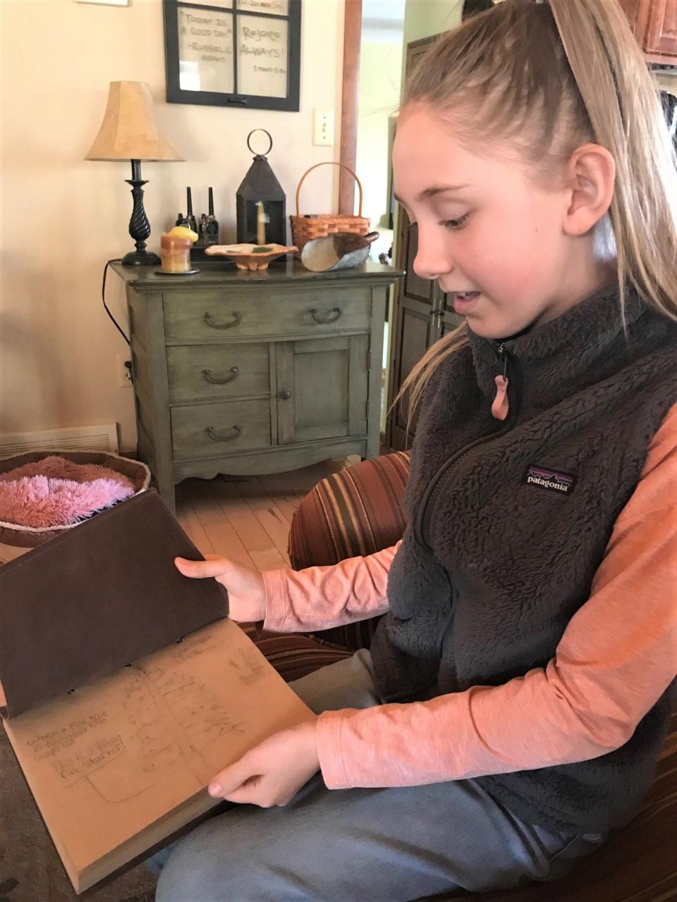 Kiala Dean, 11, shows a sketchbook she draws in when out in the woods of her family's 10-acre property. She was recently featured on the Discovery + streaming service show called "An American Story." Her episode was titled "Ohio: The Naturalist."