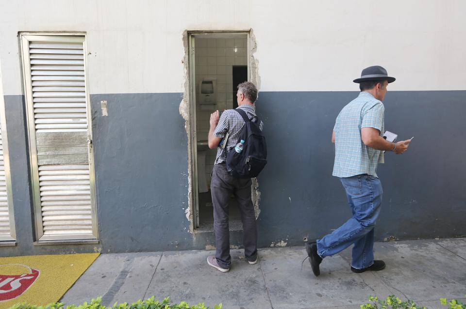 Reporters look at the bathroom the Americans allegedly damaged. (Reuters)