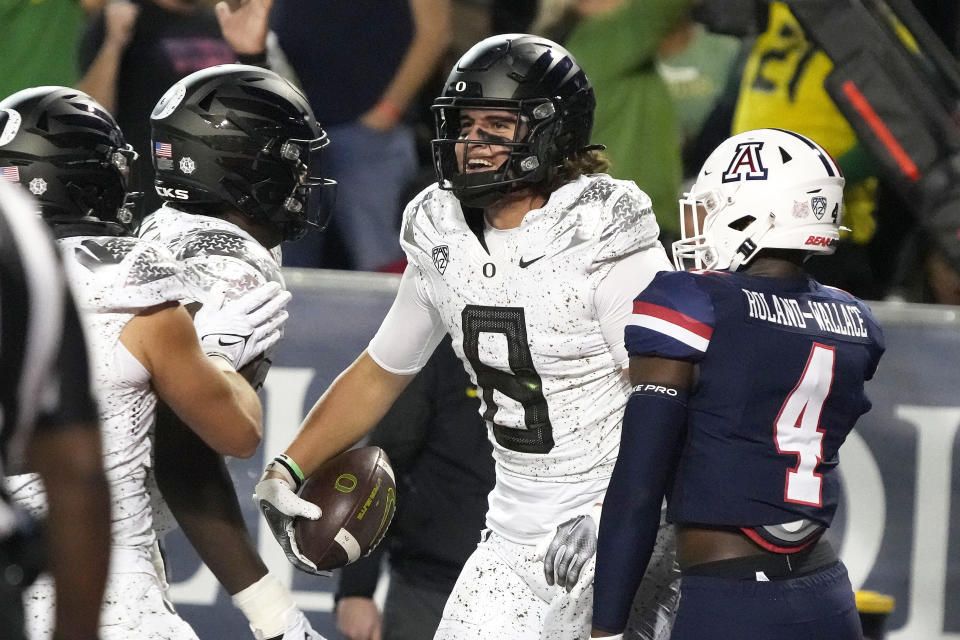 Oregon tight end Moliki Matavao (8) celebrates with teammates after scoring a touchdown against Arizona during the first half of an NCAA college football game Saturday, Oct. 8, 2022, in Tucson, Ariz. (AP Photo/Rick Scuteri)