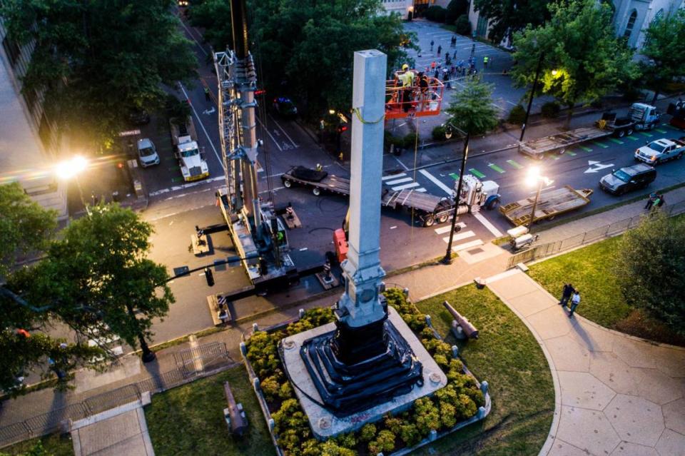 Crews work to try to dismantle the obelisk of the North Carolina Confederate Monument Tuesday, June 23, 2020 at the State Capitol.